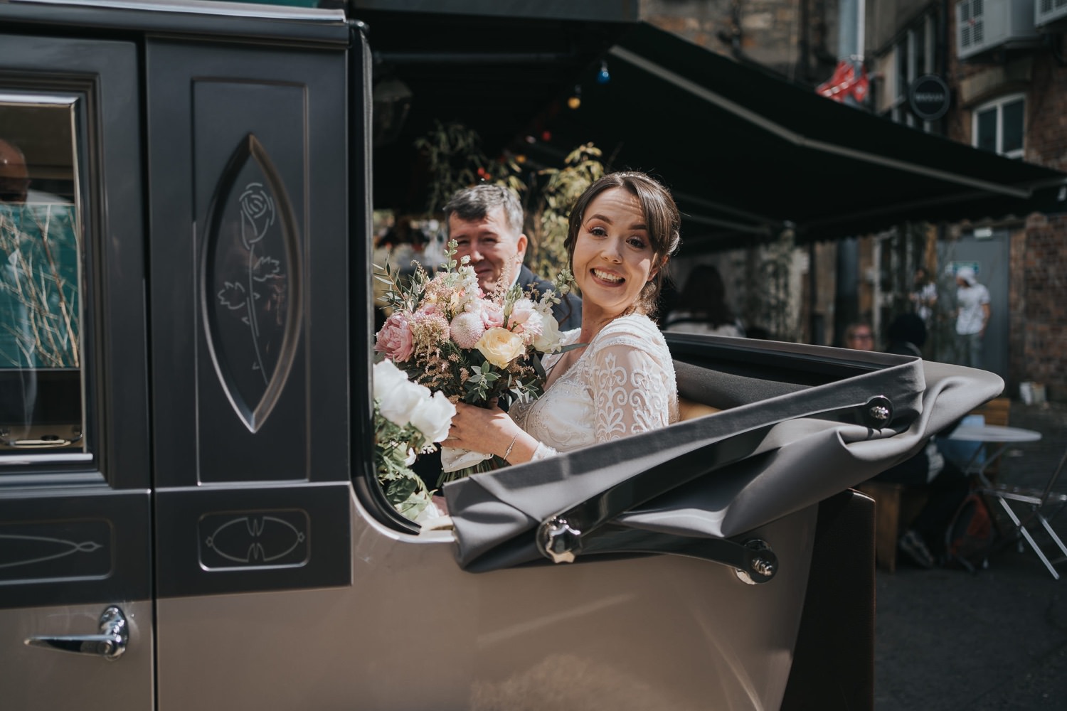 A bride sits in her wedding car at The Bothy Glasgow