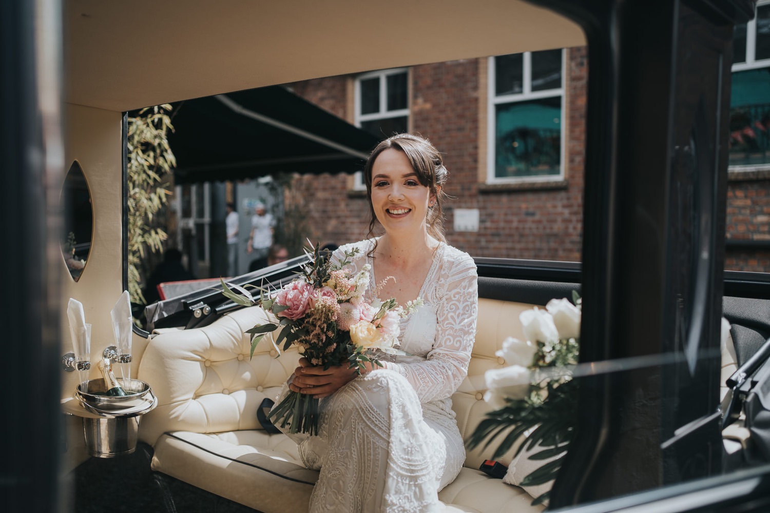 A bride sits in her wedding car at The Bothy Glasgow