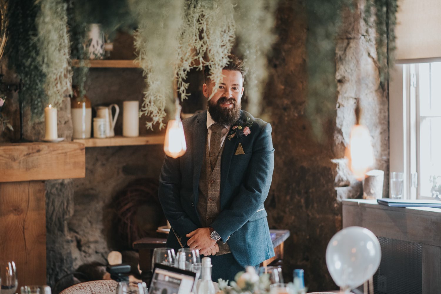 A groom smiles as he waits for his bride at The Bothy Glasgow