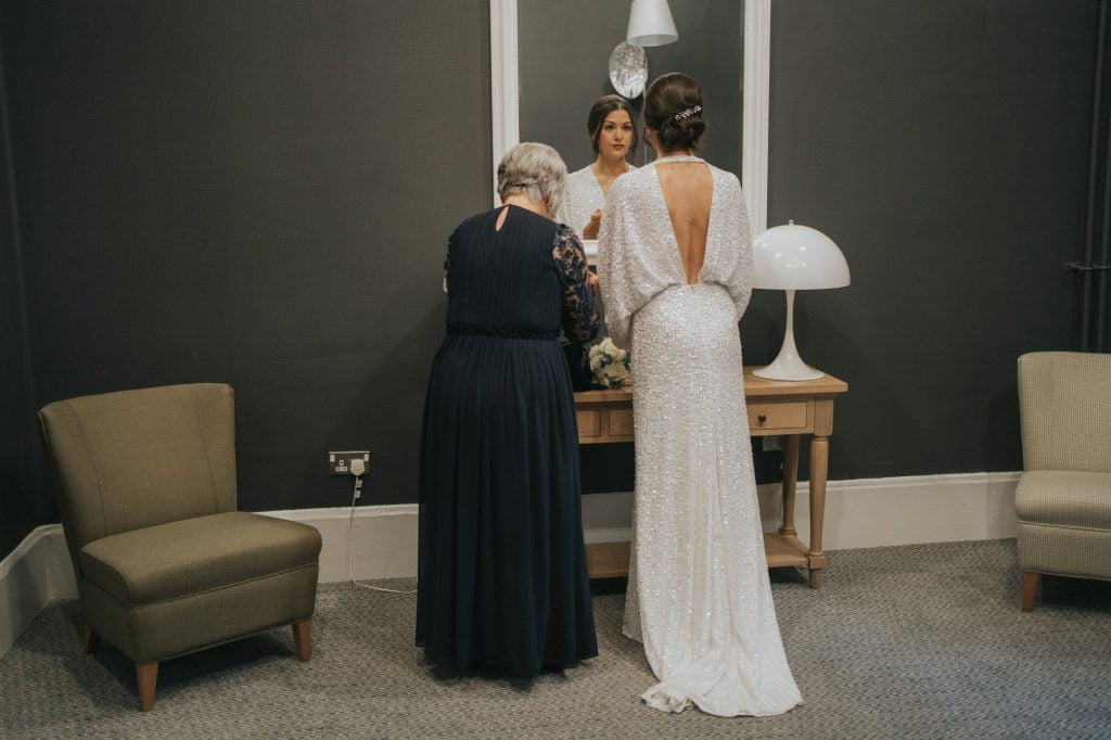 The bride and her Mum look into the mirror at 23 Montrose street just before she gets married