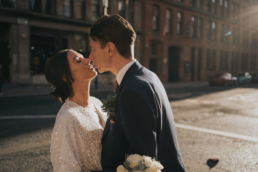 The bride and groom kiss outside 23 Montrose street
