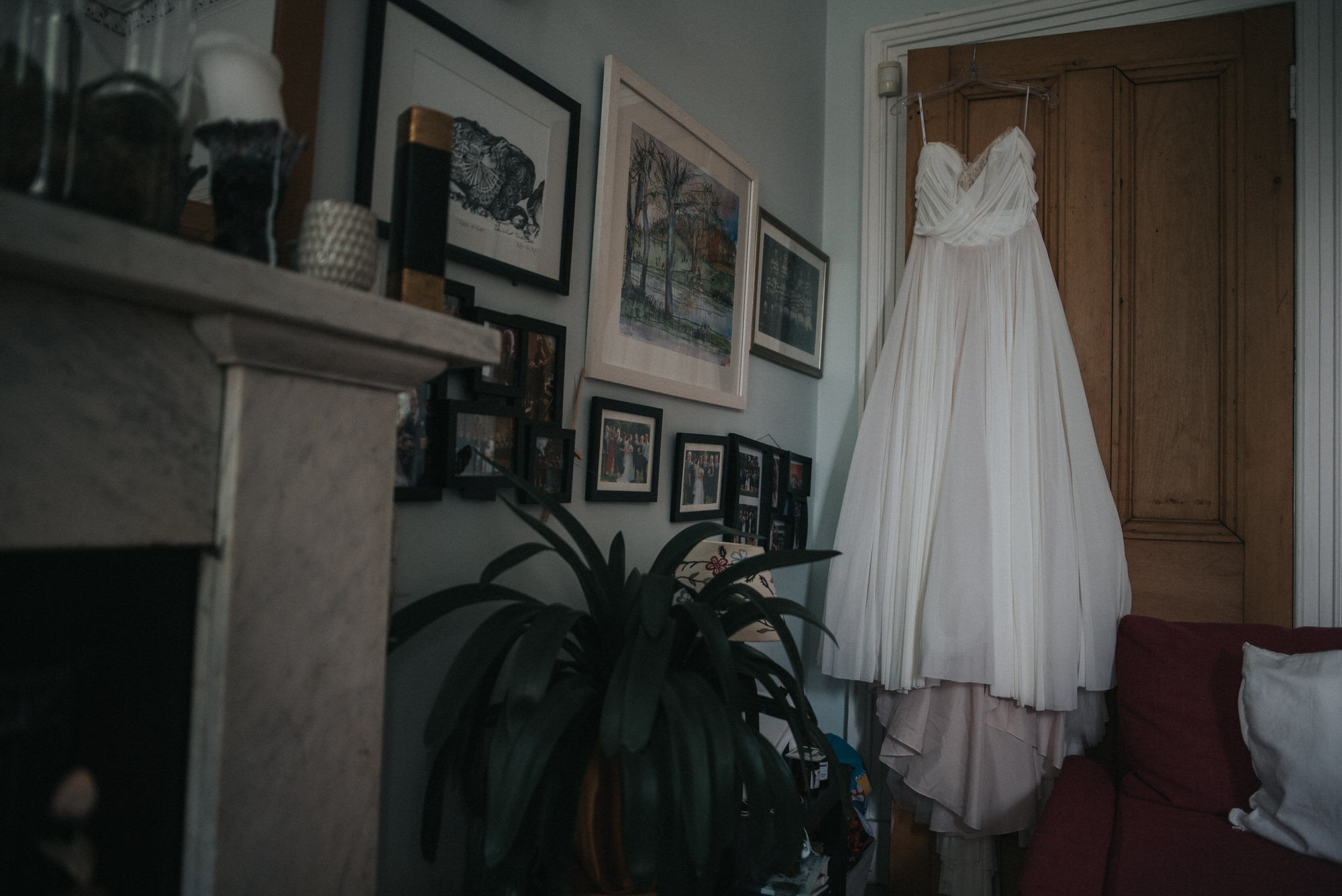 The brides Dress hangs from the door