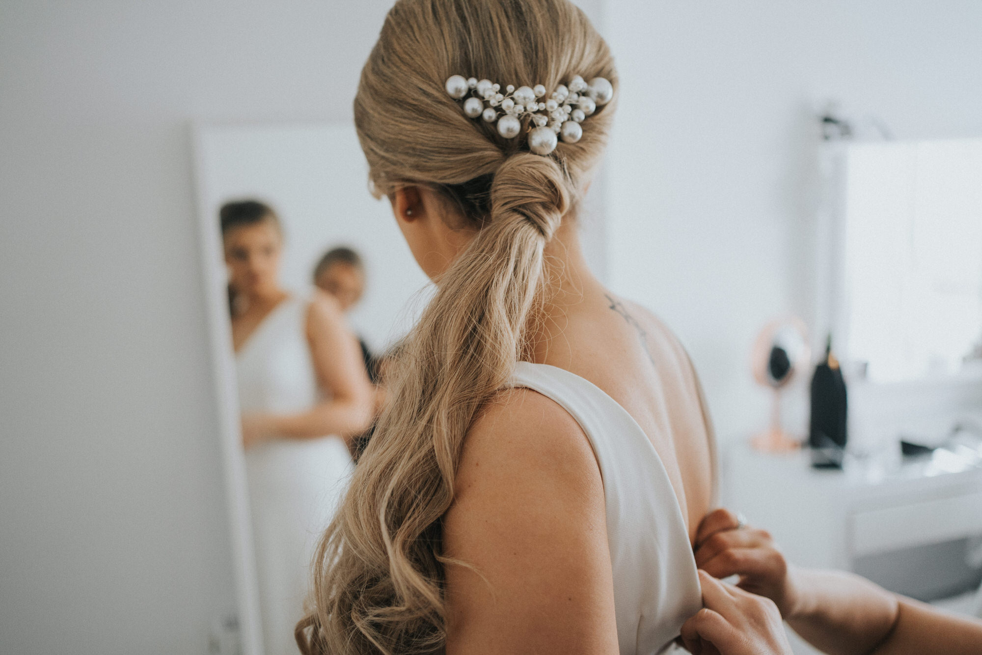 The bride looks at herself in the mirror