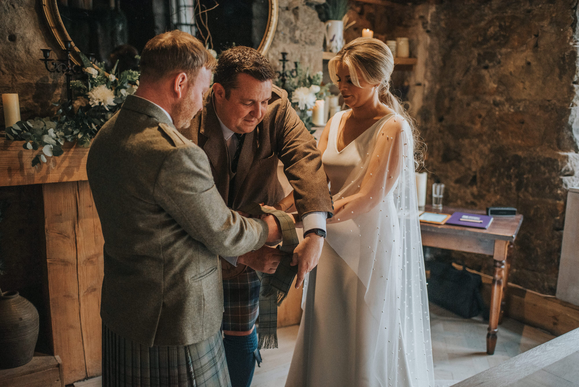 Alan Barr Humanist ties a hand fasting ribbon on the couple - He is tying the knot atThe Bothy, Glasgow!
