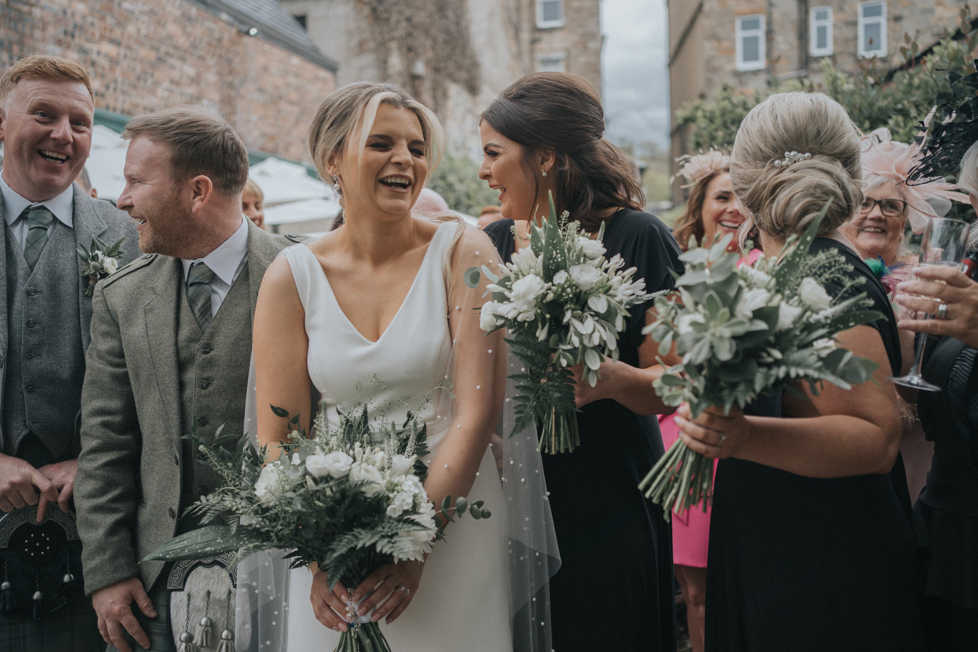 The bride laughs with her bridesmaid at The Bothy, Glasgow
