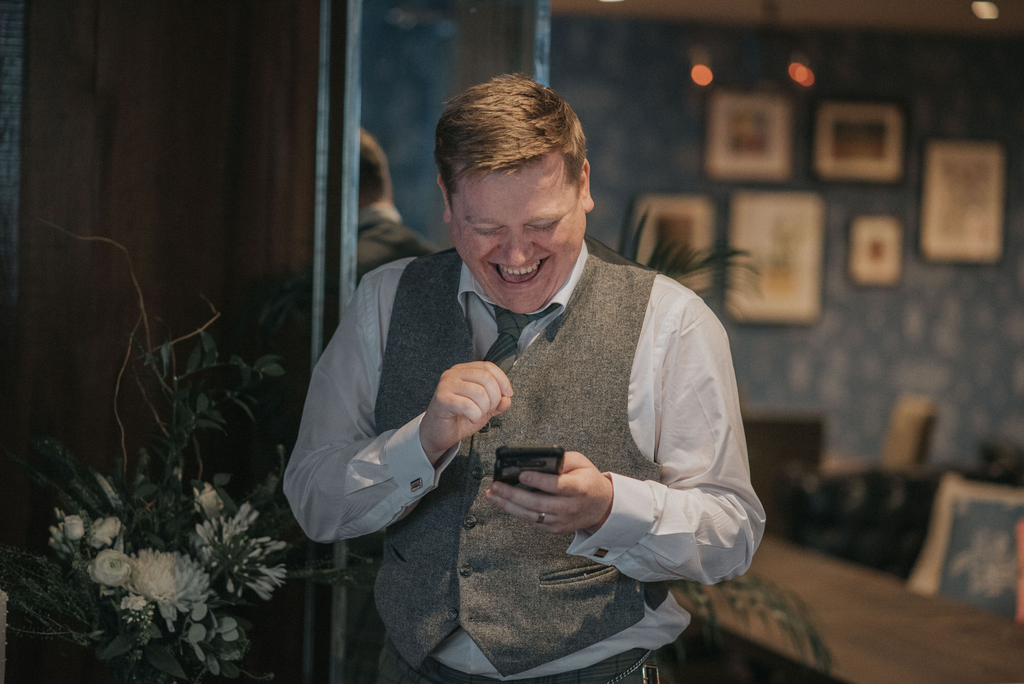 The best man laughs during his speech