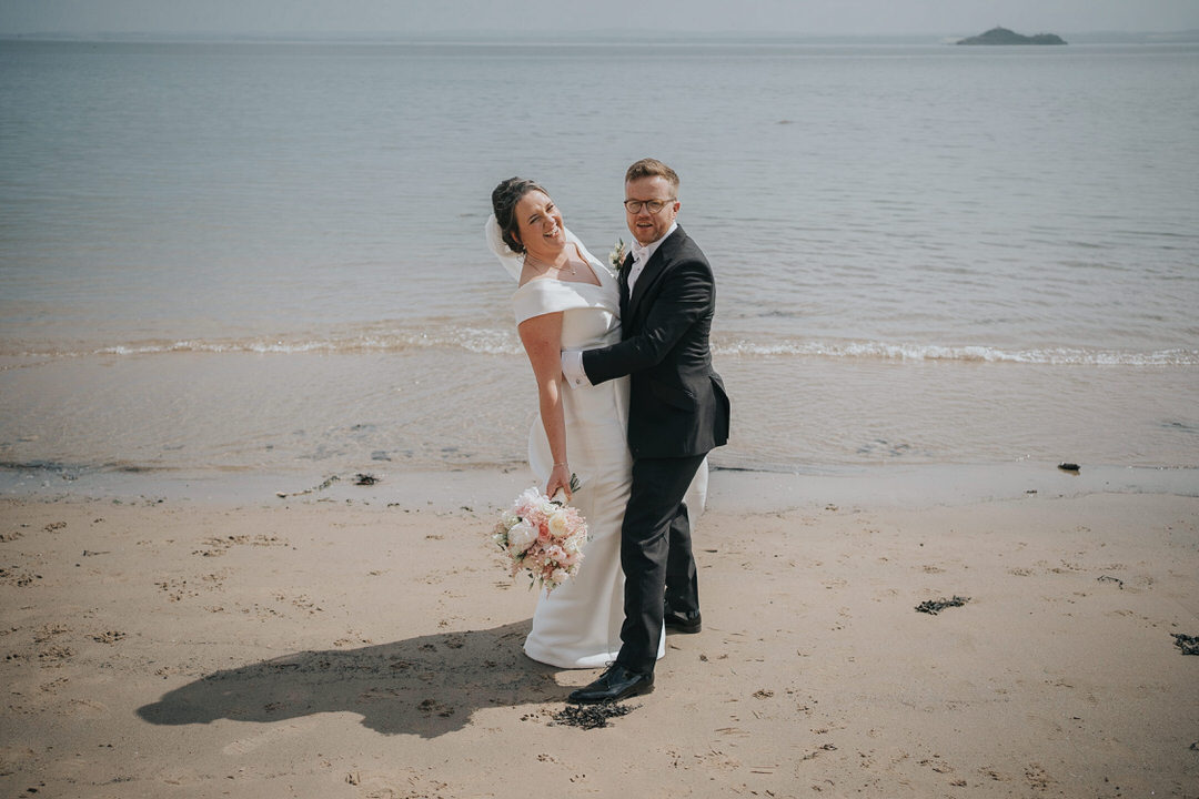 Burntisland Beach wedding photography - a couple laughing on the beach
