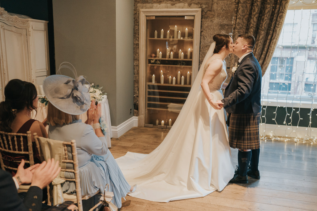 The bride and groom share a first kiss at Citation Weddings & Events in Glasgow