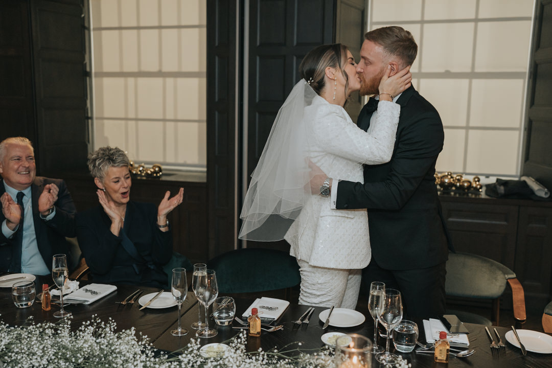 A bride and groom kiss at their Chic Glasgow City Wedding at the Kimpton Blythswood