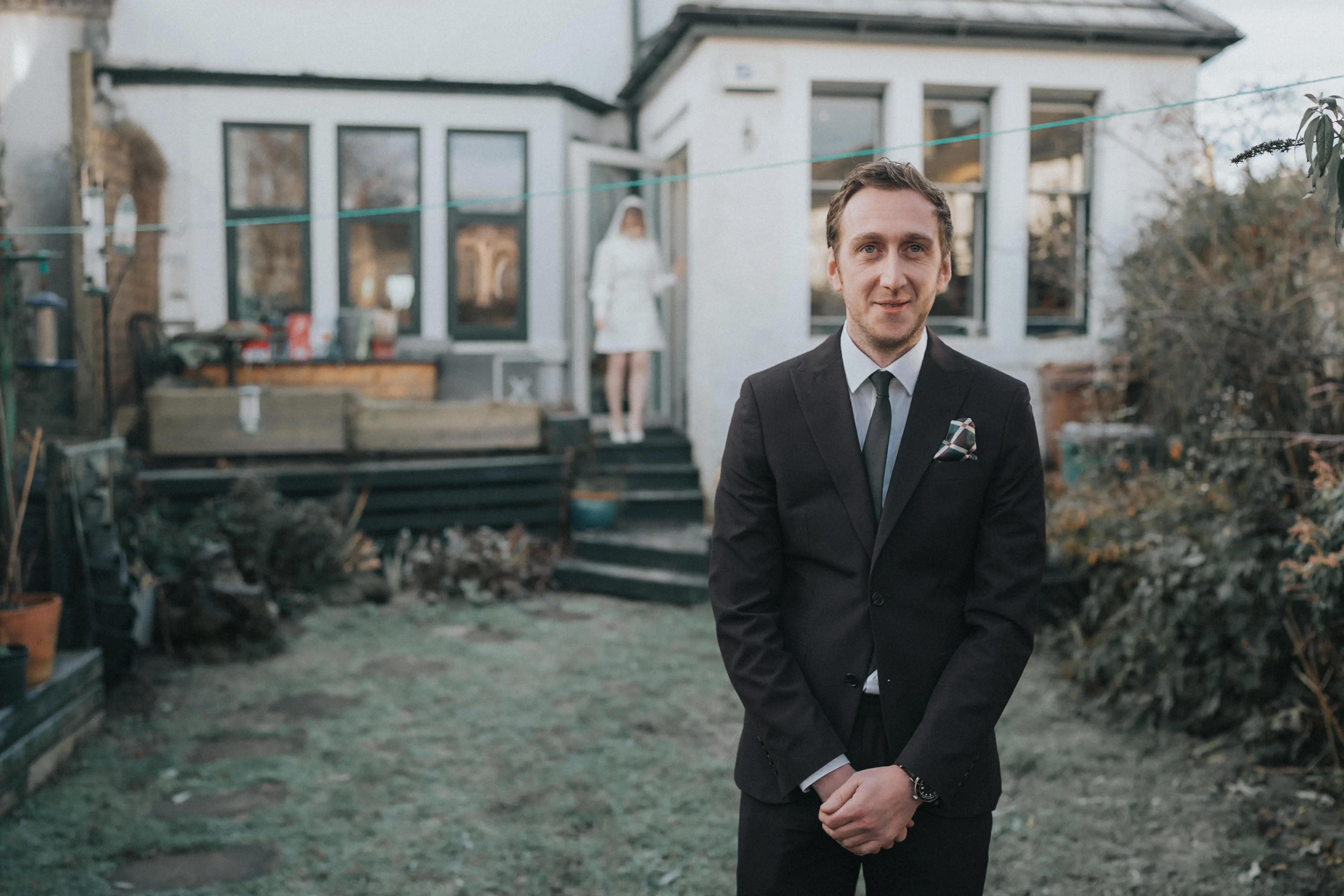 A groom has his first look with his bride before their Queens Park Bowling Club Wedding